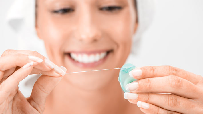 woman holding dental floss